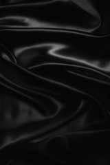 black abstract background luxury cloth or liquid wave or wavy folds of grunge silk texture satin velvet material or luxurious Christmas background or elegant wallpaper design, background