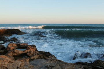 Fototapeta premium Storm waves on the beach coast summer heat stones sky water Mediterranean Spain