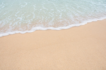 Soft wave of sea on empty sandy beach Background with copy space