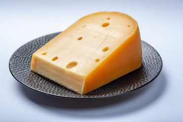 One piece of traditional Dutch old hard cheese made from cow milk