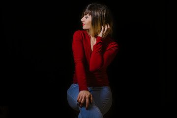 blonde woman posing on black background