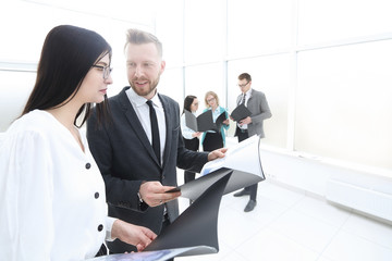 business colleagues studying business documents standing in the office