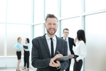 successful businessman signing document standing in the office