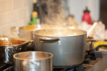 Pots cooking on stove with steam