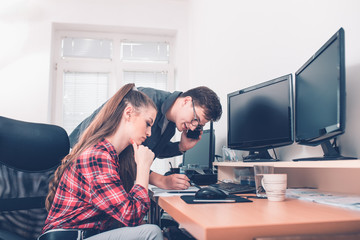 Two young colleagues making final decisions discussing working plans