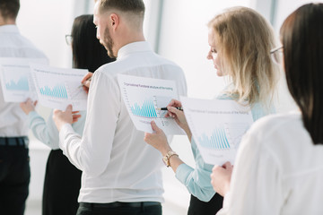 close up. employees with financial reports standing in line