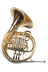 French horn on a white table. Beautiful polished musical instrument.