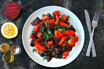 Salad of baked beets, pumpkins and carrots. Warm salad of winter vegetables. Healthy vegan salad with baked vegetables. Beet salad with pumpkin and carrot.