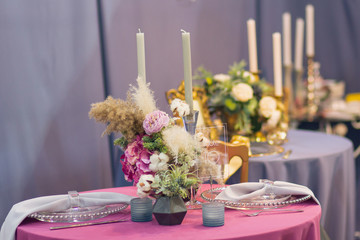 Beautiful table set with flowers and candles for a wedding dinner