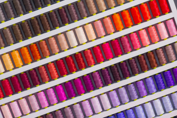 Background spool of sewing threads colorful sort in diagonal