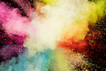 Colored powder explosion on black background. Freeze motion.