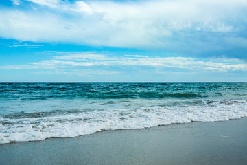White sand and blue sea with waves
