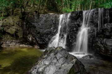 Fototapeta na wymiar Waterfall in the green forest. Suoi Tranh, Phu Quoc island in Vietnam. Beautiful nature landscape background