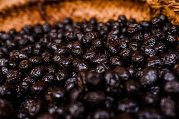 Basket with nutritious dried black olives, snack typical of the Mediterranean countries