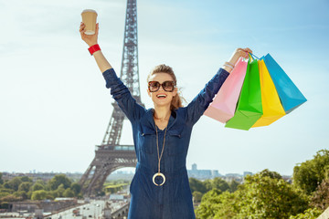 happy young traveller woman shopper and coffee cup rejoicing