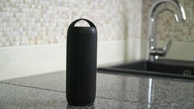 Bluetooth speaker plays music in a kitchen