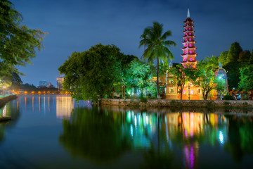Hanoi city in Vietnam at night. Beautiful view to Tran Quoc Pagoda - famous landmark