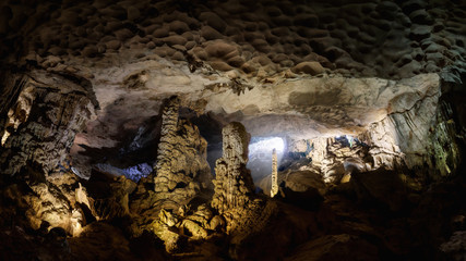 Cave deep dark inside near entrance. Panoramic view. Underground of stone rock mountain. Ha Long Vietnam nature background