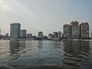 Fototapeta premium Big buildings on the coast of Nile river. Cairo city, Egypt