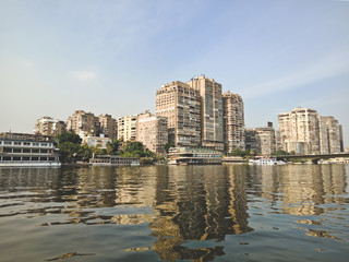Obraz premium Big buildings on the coast of Nile river. Cairo city, Egypt