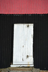 Corrugated iron building painted red and black