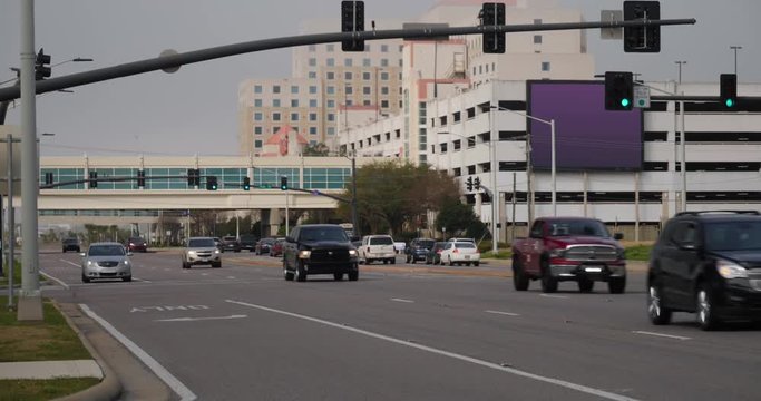 A daytime overcast establishing shot of traffic on Route 90 Beach Boulevard in downtown Biloxi, Mississippi.  	