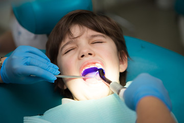 Boy at a dentist office, new teeth examination and treatment of cavities
