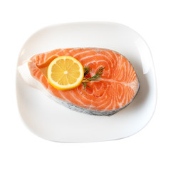 Fresh Salmon Steak On Dinner Plate Wih Lemon Slices Isolated On White. Clipping Path incluted