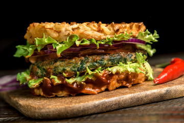 Healthy lifestyle, proper nutrition. Healthy rice burger with vegetables, herbs and cutlet