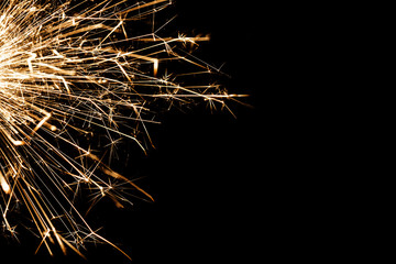 New years eve sparkler isolated on black. Shiny blow of firework sparks.	