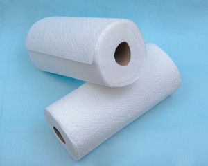 Soft strong and absorbent paper towel isolated on blue under pad.