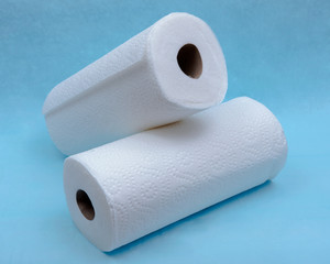 Soft strong and absorbent paper towel isolated on blue under pad.