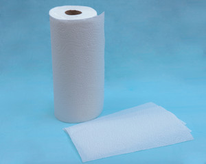 Soft strong and absorbent paper towel isolated on blue under pad.