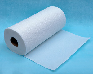 Soft strong and absorbent paper towel isolated on blue under pad.