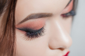 Amazing Bright eye makeup with a wide arrow. Brown and red tones, colored eyeshadow.