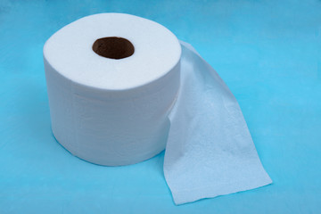 Soft strong and absorbent white toilet paper isolated on blue under pad.
