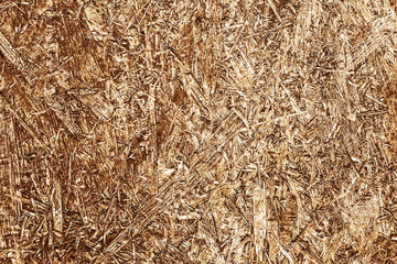 Brown chip board background. Wooden osb plywood pattern texture.