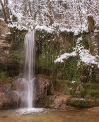 Obraz premium The Linn waterfall in the snow-covered forest in winter. Taken near Linn, Switzerland, in canton of Aargau.