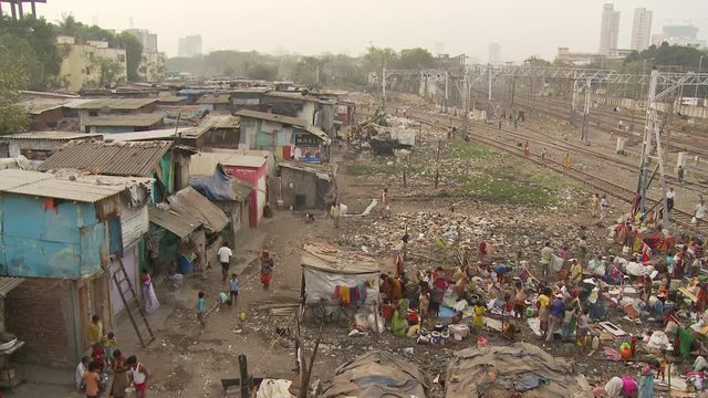 WS HA People washing clothes in slum area near train station / Mumbai, India