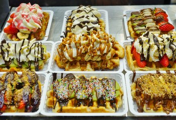 Belgian waffles with colorful sweet toppings for sale on the street in Brussels