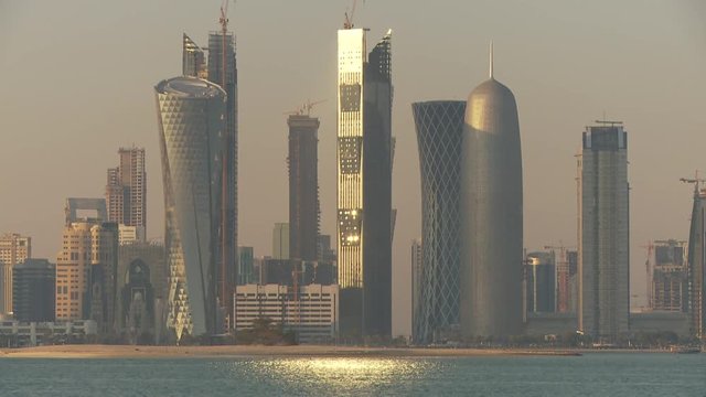 WS Financial district skyline seen across Doha Bay at sunset / Doha, Qatar