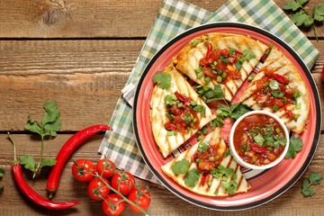Quesadilla grill with spicy salsa with chili pepper. Mexican traditional food, wheat tortillas. top view. 