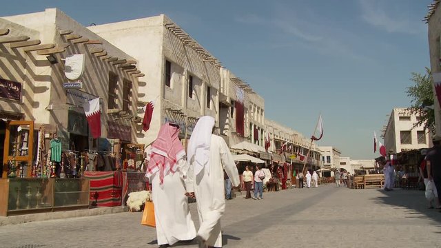 WS Souq Waqif with market stalls and Qatari flags on building / Doha, Qatar
