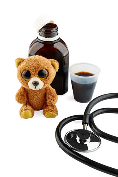 Plush toy, stethoscope and bottle with medicine. Isolated.