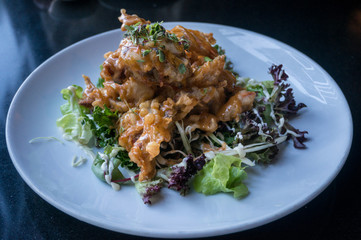 Tempura crab served with sauce and lettuce leaves