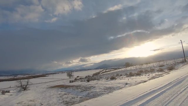 Gh 010034 Drive Plate Pov Side View Passing Snow Covered Hills To Setting Sun