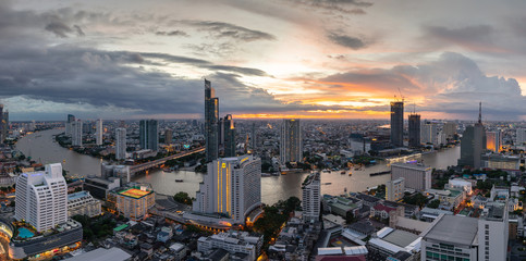 beautiful sunset curve Chao Phraya River panoramic Cityscape of Bangkok city at night on 2018 , panorama the Metropolis Bangkok City downtown urban landscape Thailand