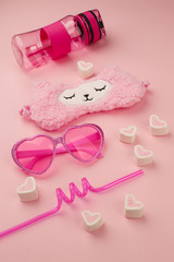 set of cute kawaii accessory for young girl in pink color, sunshine summer concept, trendy lama and candy pink closeup