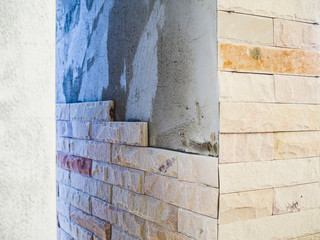 Installing sandstone decorative tiles on the pillars house