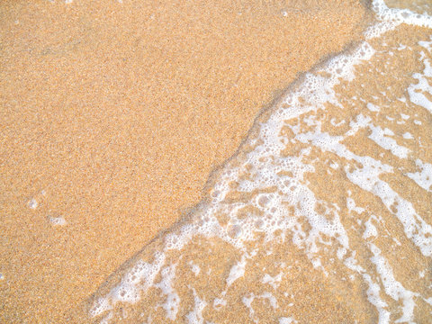 Close uo of ocean wave on sandy beach
